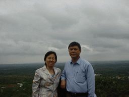 Miaomiao`s parents at the top of the Mt. Fengluling volcano crater at the Hainan Volcano Park, with a view on the surrounding area