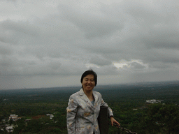 Miaomiao`s mother at the top of the Mt. Fengluling volcano crater at the Hainan Volcano Park, with a view on the surrounding area