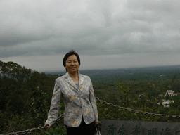 Miaomiao`s mother at the top of the Mt. Fengluling volcano crater at the Hainan Volcano Park, with a view on the surrounding area