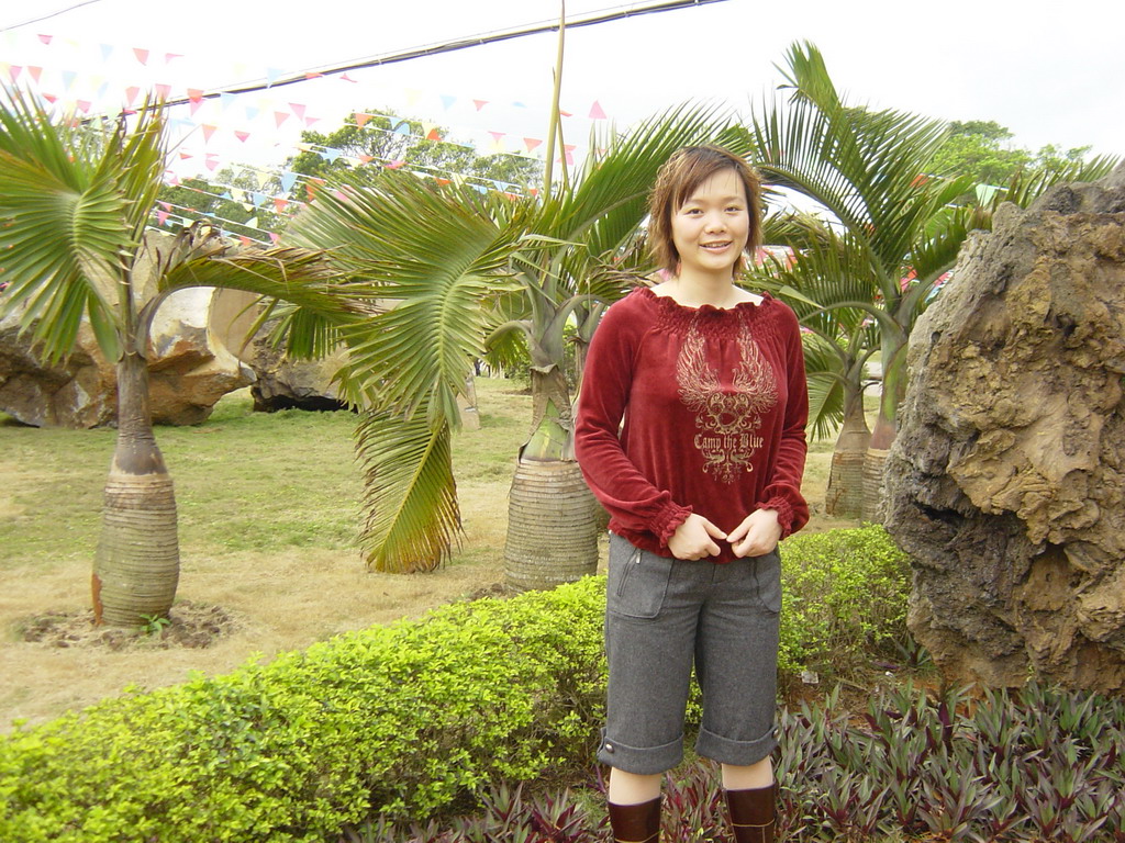 Miaomiao with palm trees at the Hainan Volcano Park