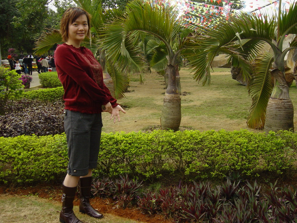 Miaomiao with palm trees at the Hainan Volcano Park