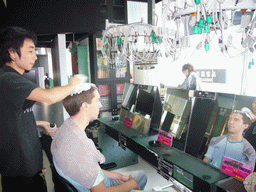 Tim getting a haircut at a barber in the city center