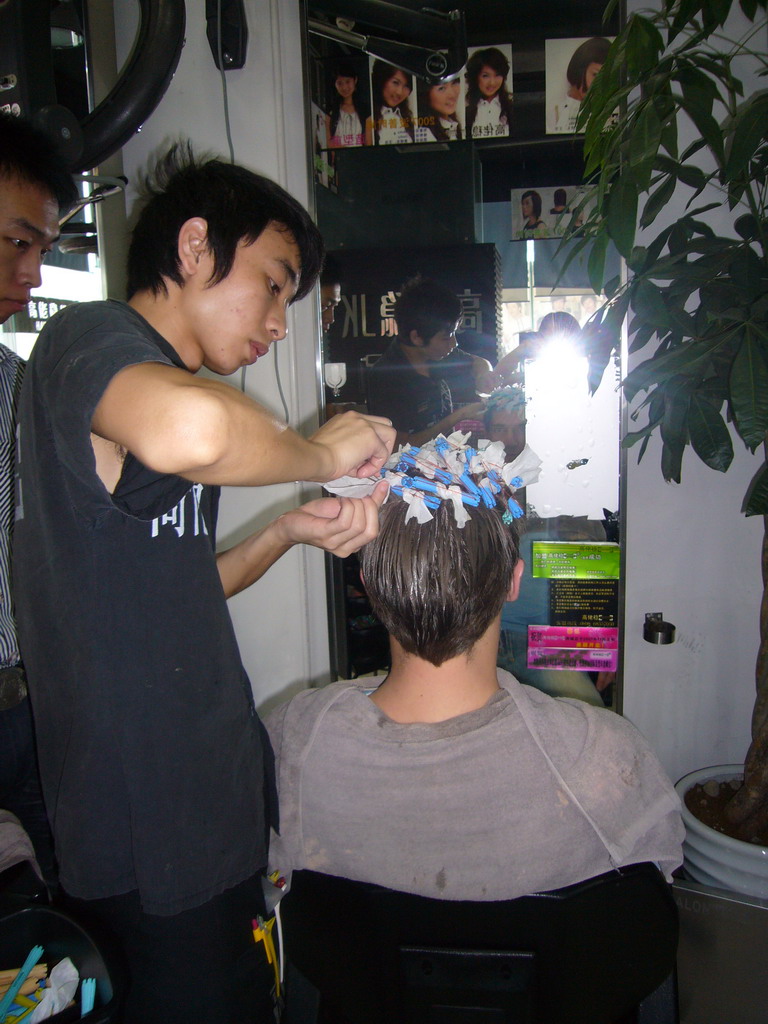 Tim getting a haircut at a barber in the city center