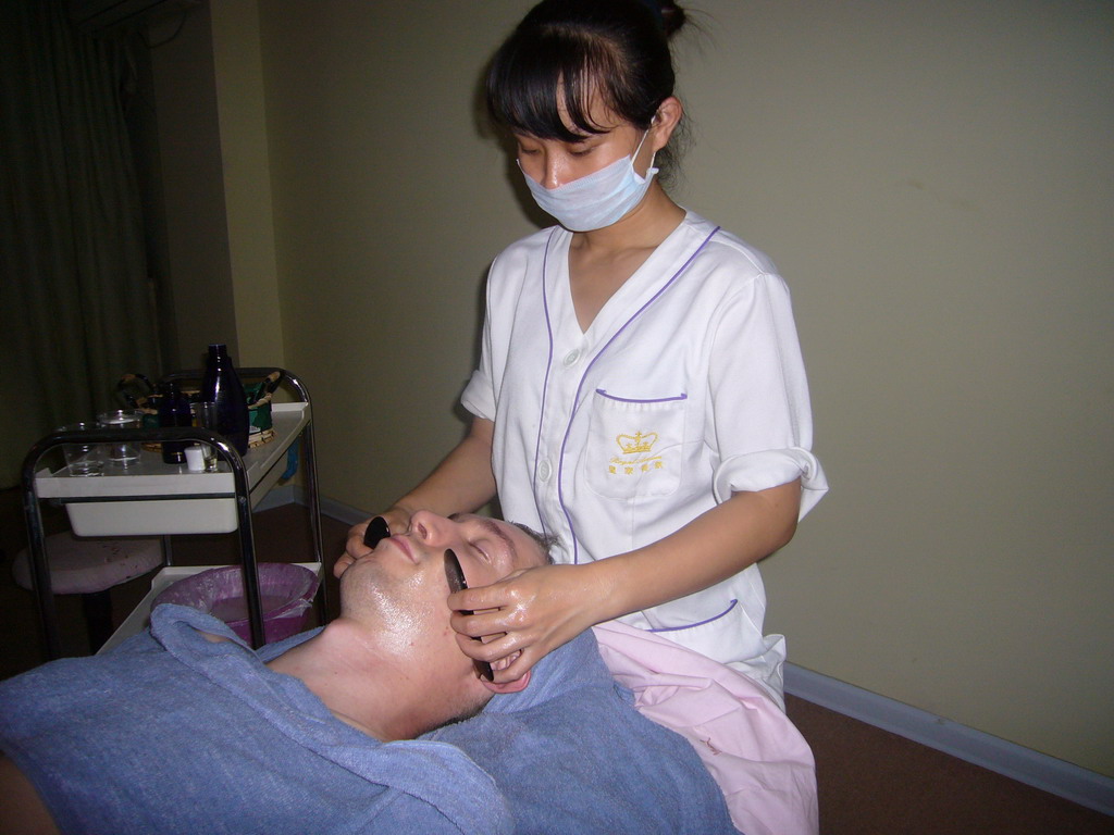 Tim having a facial massage at a massage salon in the city center