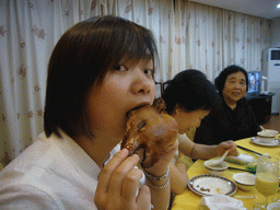 Miaomiao eating a pig`s head at a restaurant in the city center