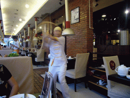 Cook preparing noodles, in a restaurant in the center of the city