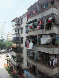 haikou_4_008 - 302 kb - 768x1024 - Apartment building in the city center with laundry drying at the balconies, viewed from a department store Apartment building in the city center with laundry drying at the balconies, viewed from a department store