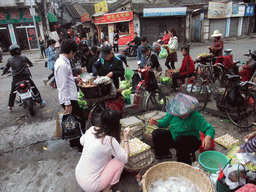 People selling eggs and vegetables in an old street at the city center