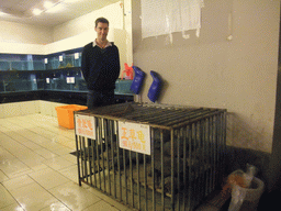 Tim at a cage with turtles in a restaurant to the south of the city center