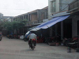 Moped in a street in the city center, viewed from a car