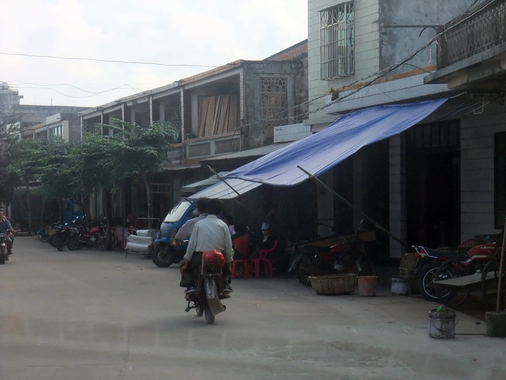 Moped in a street in the city center, viewed from a car