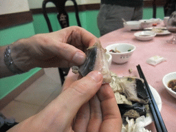 Tim eating snake meat in a restaurant at the city center