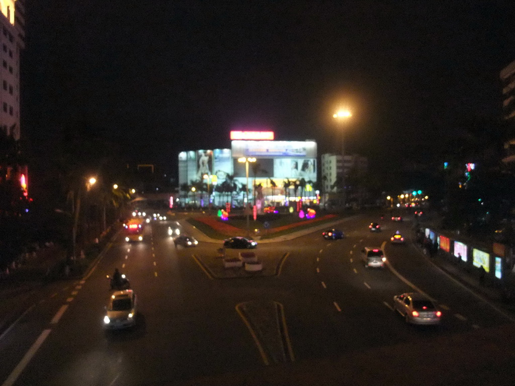 View on a road in the city center from a pedestrian bridge, by night