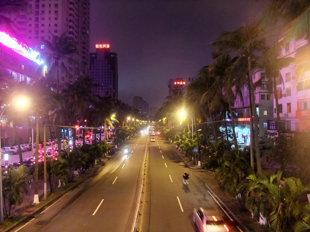 View on a road in the city center from a pedestrian bridge, by night