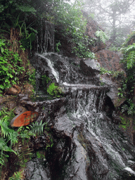 Waterfall and rock with inscriptions at the Hainan Volcano Park