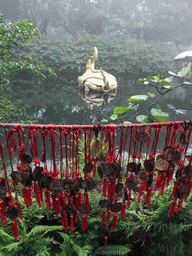 Pool with turtle and snake statue and amulets at the Hainan Volcano Park