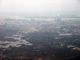 Skyline of Haikou, a bridge over the Nandu River and lakes and forest to the southeast of the city, viewed from the airplane from Zhengzhou