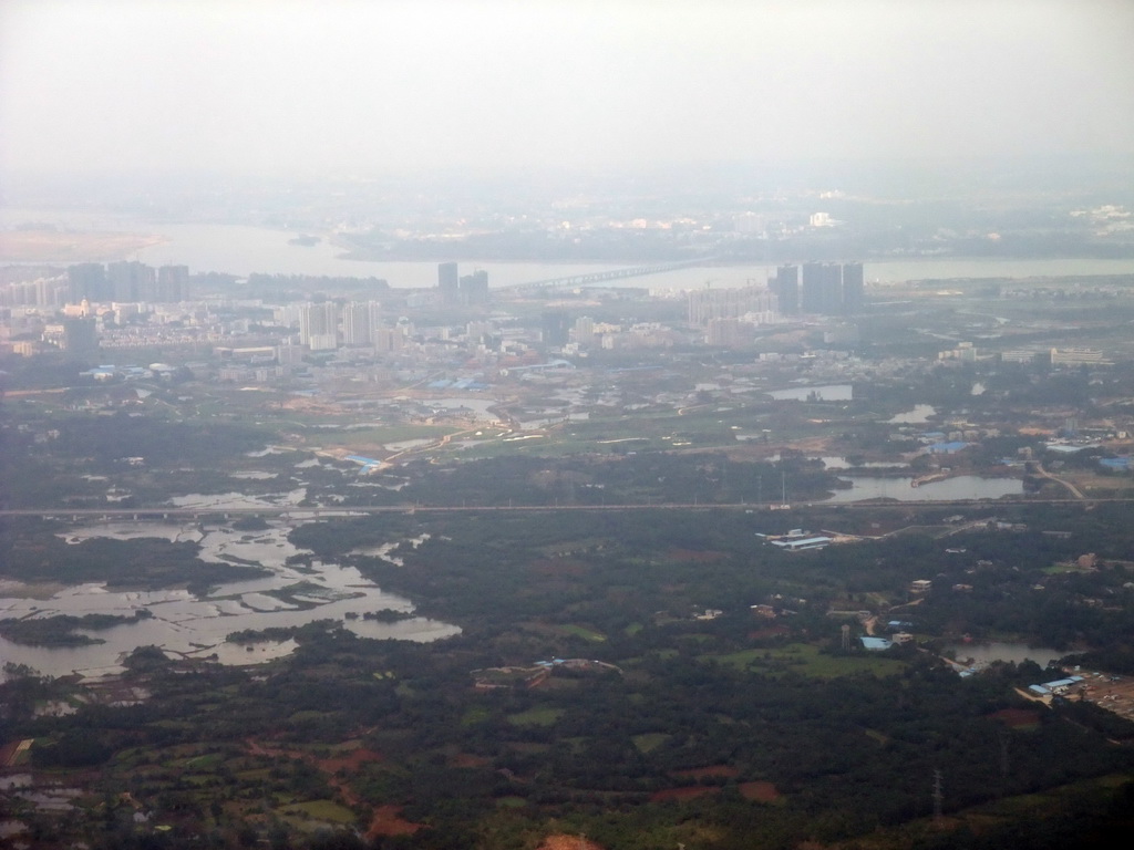 Skyline of Haikou, a bridge over the Nandu River and lakes and forest to the southeast of the city, viewed from the airplane from Zhengzhou
