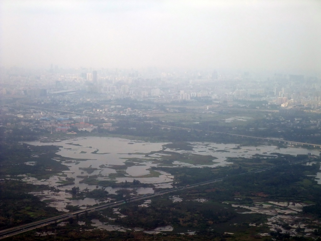 Skyline of Haikou and highways and lakes to the southeast of the city, viewed from the airplane from Zhengzhou