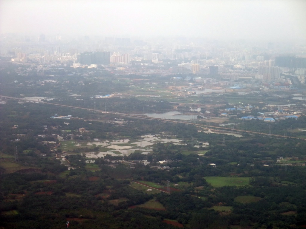 Skyline of Haikou and highways, lakes and forest to the southeast of the city, viewed from the airplane from Zhengzhou
