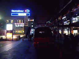Carrefour bus in front of the Carrefour shopping mall at Longhua Road, by night