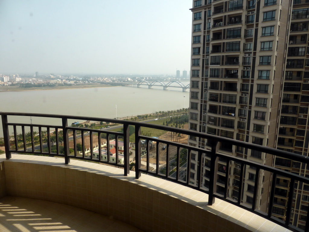 The east side of the city with the Qiongzhou Bridge over the Nandu River, viewed from the balcony of the apartment of Miaomiao`s sister