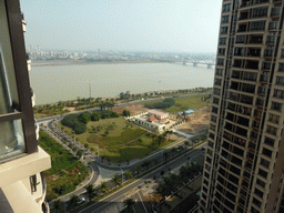 The east side of the city with the Qiongzhou Bridge over the Nandu River, viewed from the balcony of the apartment of Miaomiao`s sister