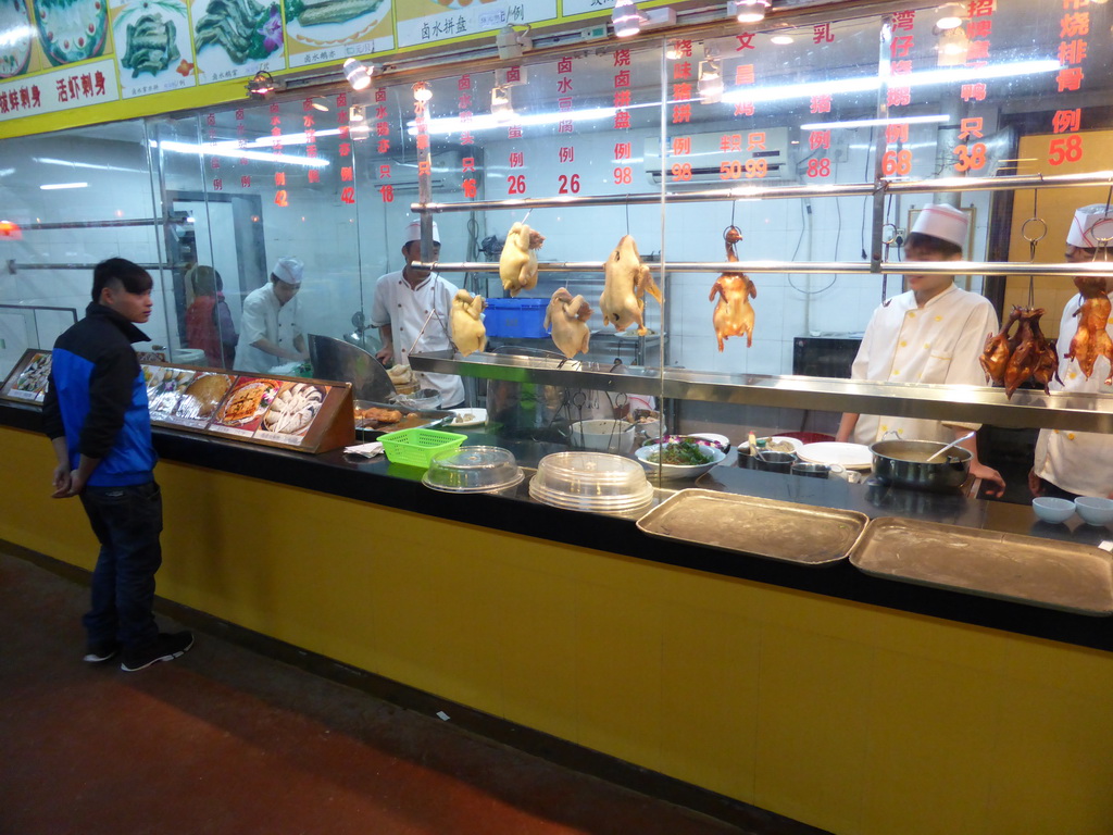 Cooks and chickens at a restaurant near Xiaoyao Lake