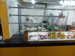 Cooks preparing food at a restaurant near Xiaoyao Lake