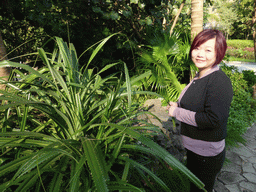 Miaomiao with a plant at the Mission Hills Golf Resort Haikou