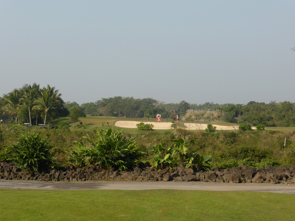 People playing golf at the golf course at the Mission Hills Golf Resort Haikou