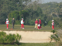 People playing golf at the golf course at the Mission Hills Golf Resort Haikou