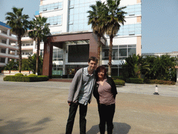 Tim and Miaomiao in front of the central building of the Hainan Overseas Chinese Middle School