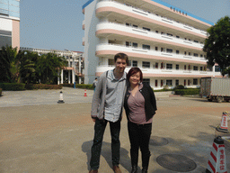 Tim and Miaomiao in front of the east building of the Hainan Overseas Chinese Middle School