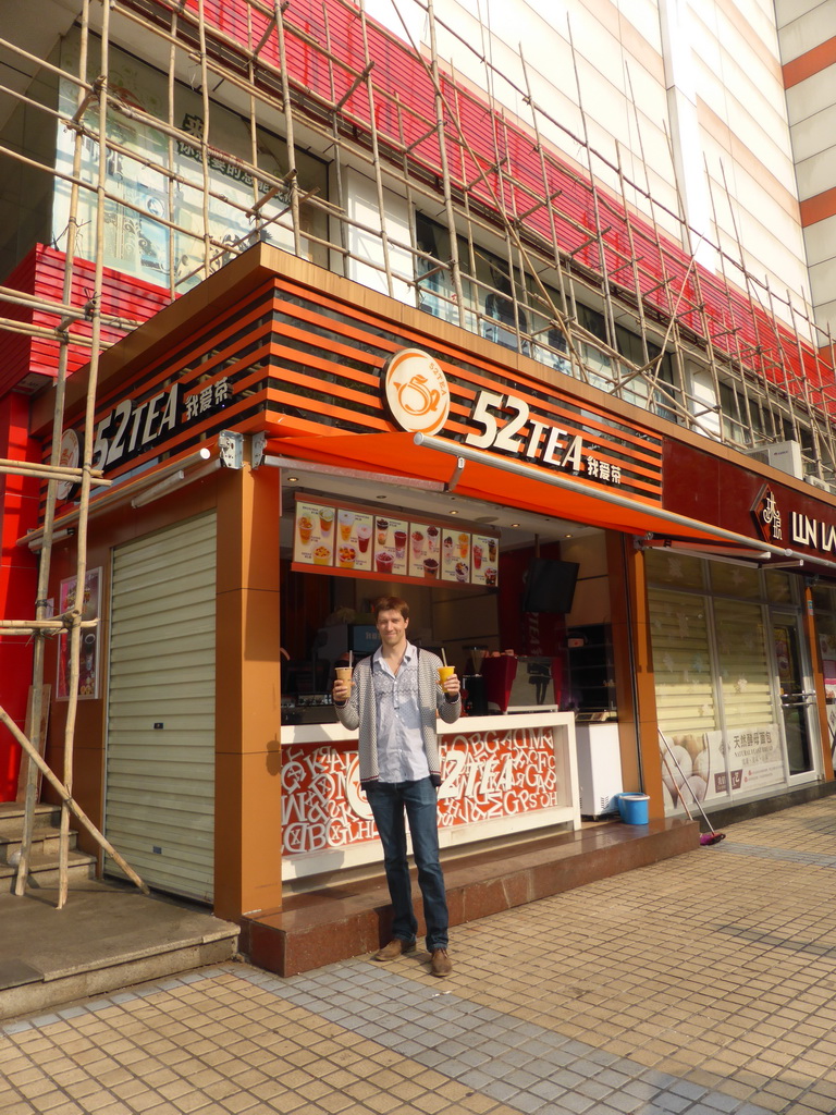 Tim with cups of bubble tea in front of the 52Tea shop at Nanbao Road