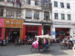 Rickshaw and scooters at Daxing West Road