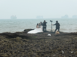 Photoshoot of a wedding couple at the beach at the Holiday Beachside Resort at Binhai Avenue and the Qiongzhou Strait