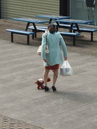 Woman with dog just outside of the Carrefour shopping mall at Haifu Road