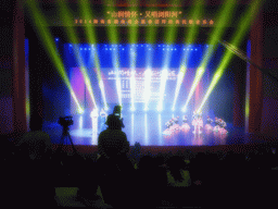 Presenters and dancers on the stage during the show for Hunan immigrants in the main hall of the Hainan Centre for the Performing Arts