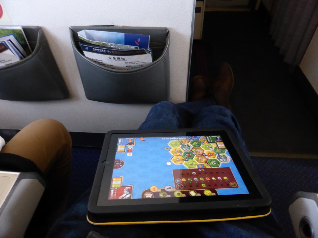 Tim with our iPad and a lot of leg space in the airplane to Xiamen