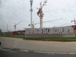 Welcome sign and cranes at the Central Business District at Guoxing Avenue, viewed from the car