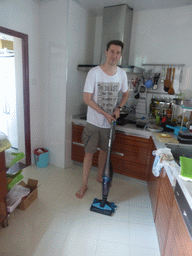 Tim with the vacuum cleaner in the apartment of Miaomiao`s sister