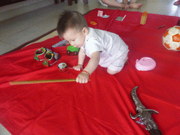 Max during the Zhuazhou ceremony for his first birthday in the apartment of Miaomiao`s parents