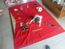 Max during the Zhuazhou ceremony for his first birthday in the apartment of Miaomiao`s parents