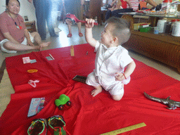 Miaomiao and Max during the Zhuazhou ceremony for Max`s first birthday in the apartment of Miaomiao`s parents