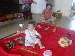 Miaomiao and Max during the Zhuazhou ceremony for Max`s first birthday in the apartment of Miaomiao`s parents