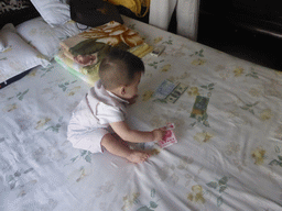 Max during the Zhuazhou ceremony for his first birthday in the apartment of Miaomiao`s parents