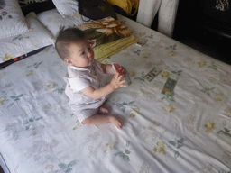 Max during the Zhuazhou ceremony for his first birthday in the apartment of Miaomiao`s parents