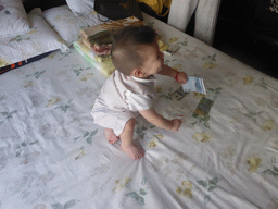 Max during the Zhuazhou ceremony for his first birthday in the apartment of Miaomiao`s parents