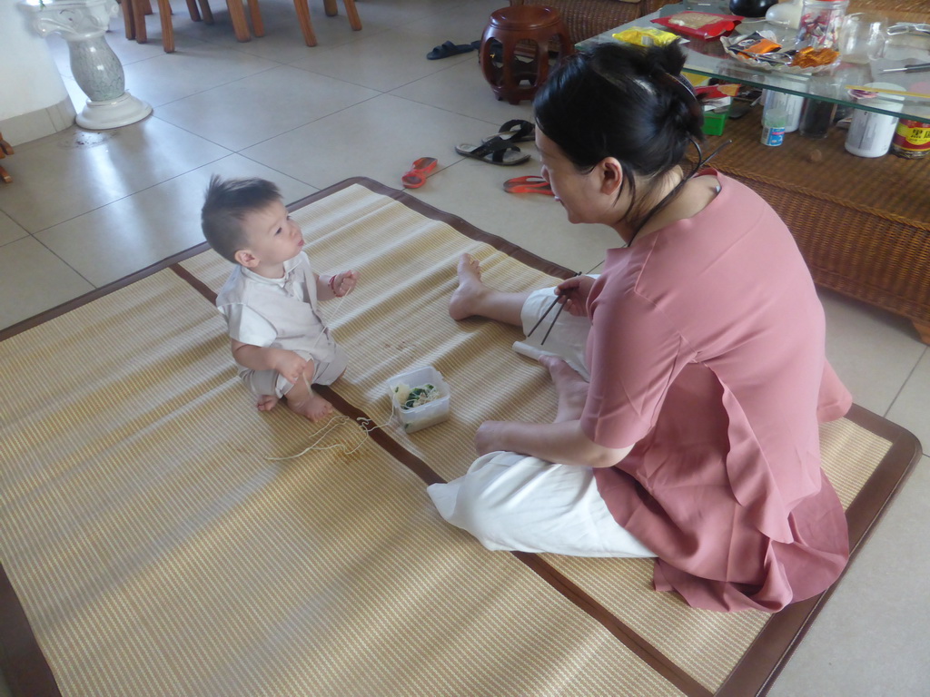 Miaomiao and Max eating noodles for Max`s first birthday in the apartment of Miaomiao`s parents